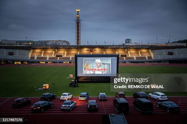 People with vital professions attend a screening of a film by Dutch director Martin Koolhoven during the first drive-in open-air cinema at the...