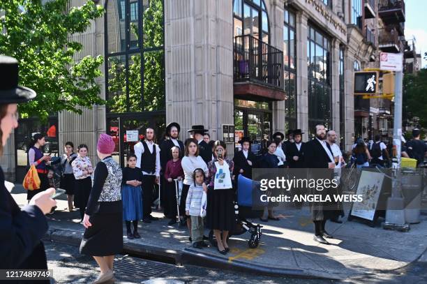 Members of the Orthodox Jewish community watch as protesters walk through the Brooklyn borough on June 3 during a "Breonna Taylor and Black Lives...