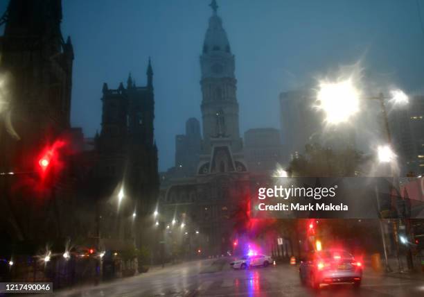 Police car blocks traffic towards City Hall during a downpour after a 6pm imposed curfew on June 3, 2020 in Philadelphia, Pennsylvania. Protests...