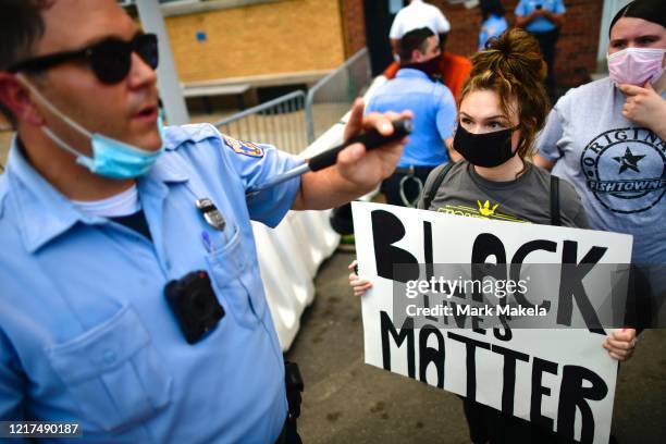 Activists confront a police officer while gathering in protest outside the 26th Police Precinct on June 3, 2020 in Philadelphia, Pennsylvania....