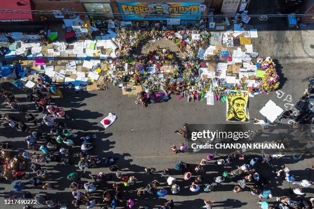 An aerial view shows people gathering to pay tribute at a makeshift memorial in honour of George Floyd, on June 3, 2020 in Minneapolis, Minnesota....