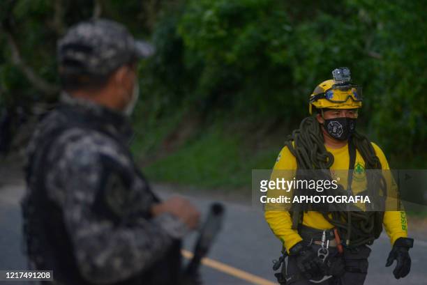 First responder carrying rope walks out of the scene of a mud slide during the search for 7 people that where buried after a mud slide occurred on...