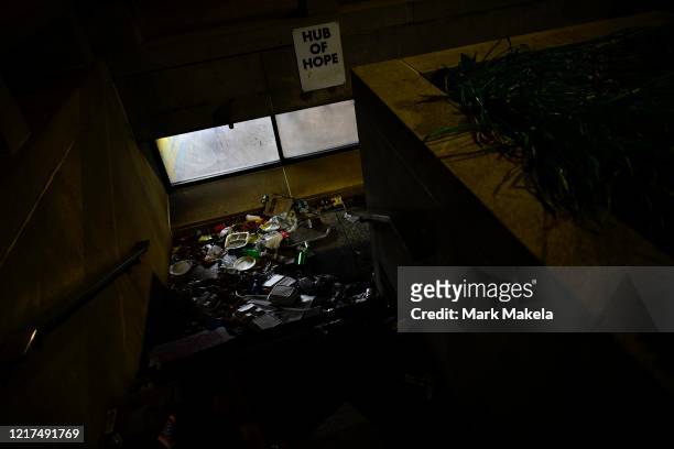 Trash collects in the well of an adjoining City Hall plaza below a sign stating "HUB OF HOPE" after five days of protests and widespread looting on...