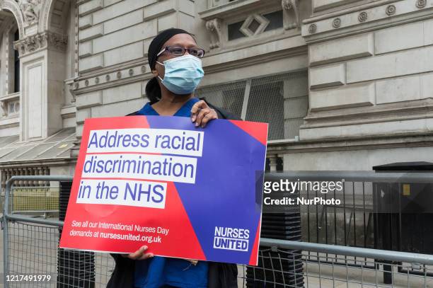 Group of nurses wearing face masks protest outside Downing Street demanding a pay rise, effective protection against COVID-19 and highlighting a...