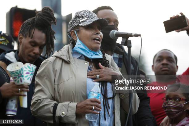 Marcia Carter-Patterson speaks during a vigil at the intersection where her son Manuel Ellis, a 33-year-old black man, died in Tacoma Police custody...