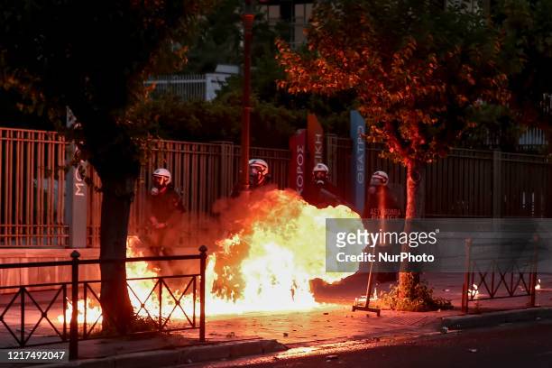 Riot police officers amid flames by petrol bombs thrown by protesters close to the U.S. Embassy, during a demonstration over the death of George...