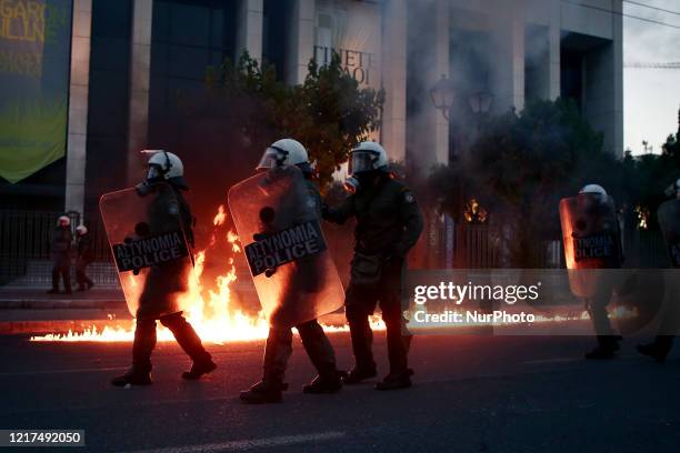 Riot police officers amid flames by petrol bombs thrown by protesters close to the U.S. Embassy, during a demonstration over the death of George...