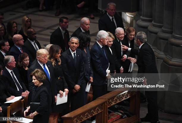 Former president George W. Bush, President Donald Trump, and former presidents Barack Obama, Bill Clinton and Jimmy Carter look on during a funeral...
