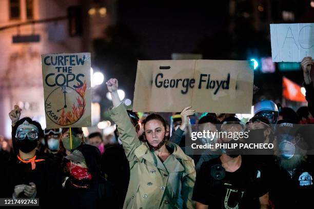Demonstrators attend a "Sit Out the Curfew" protest against the death of George Floyd who died on May 25 in Minneapolis whilst in police custody,...
