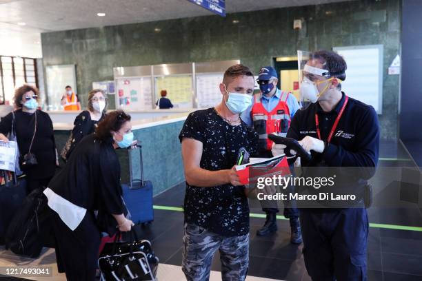 Passengers have their tickets checked as they prepare to board the first Freccia Rossa high speed long haul train connecting Reggio Calabria and...