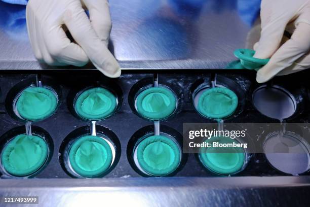 An employee loads rolled up condoms onto a conveyor on the production line at a Karex Bhd. Facility in Port Klang, Selangor, Malaysia, on Wednesday,...