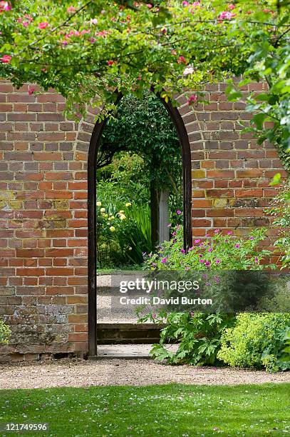 entrance into walled cottage garden - formal garden stock pictures, royalty-free photos & images