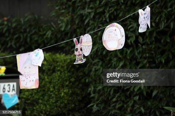 An string of coloured easter eggs and bunnies adorn a driveway in Titirangi on April 08, 2020 in Auckland, New Zealand. New Zealanders are being...