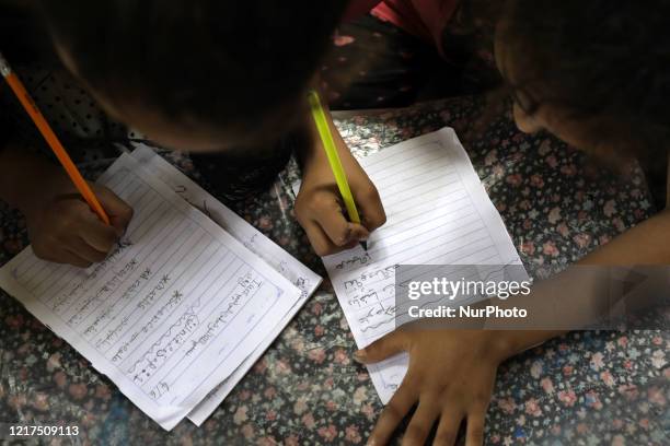 Children attend an Arabic language lesson given by a Palestinian school girl Fajr Hmaid as schools are shut due to the coronavirus disease...