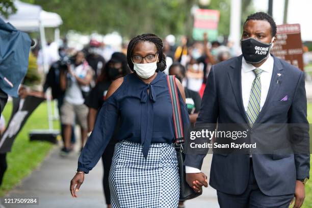 Wanda Cooper, left, mother of Ahmaud Arbery, and attorney Lee Merritt, leave the Glynn County courthouse during a court appearance by Gregory and...