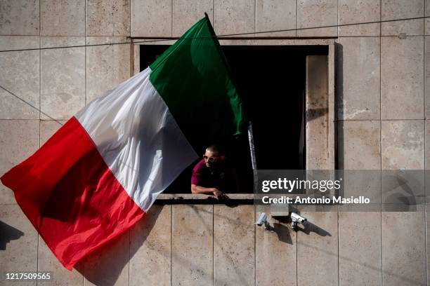 Member of far right political party Casapound waves an Italian flag during the impoundment of the Casapound headquarters, during phase three of the...