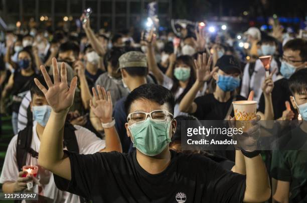 Man gestures and shouts slogans while holding a candle during the Tiananmen Square vigil remembrance in Causeway Bay, Hong Kong on June 04, 2020....