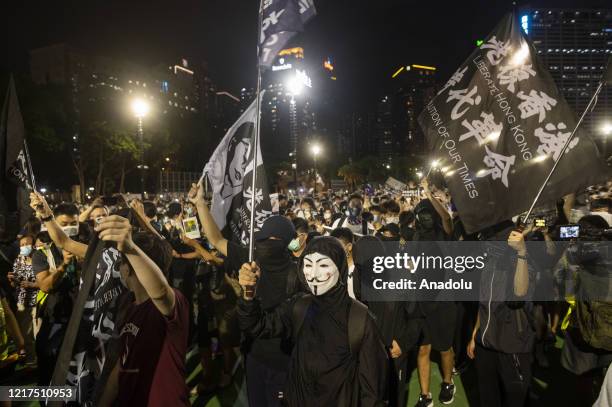 People wave banners and flags of independence and in support of the pro-democracy movement during the Tiananmen Square vigil remembrance in Causeway...