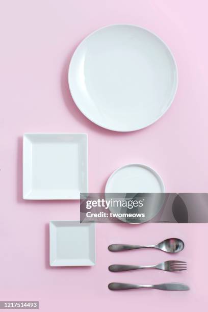 empty plates on pastel coloured background. - white plate stock pictures, royalty-free photos & images