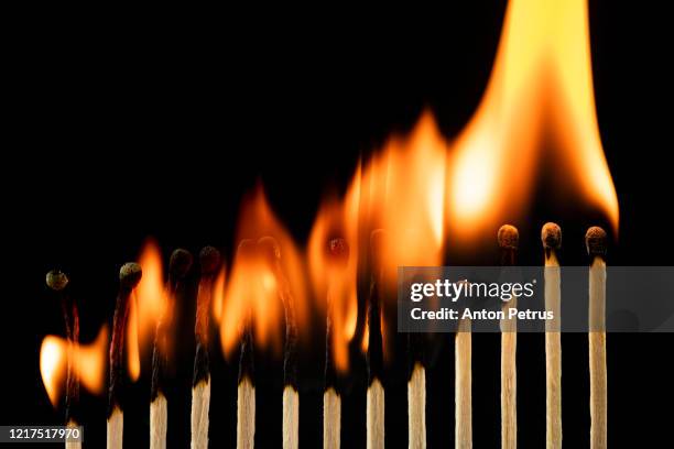 burning matches concept. ignition matches in sequence, metaphor of influence, chain reaction, domino effect. - matchstick ignition stock pictures, royalty-free photos & images