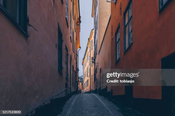 a narrow alley in the old town of stockholm seen during the corona pandemic - tighten stock pictures, royalty-free photos & images