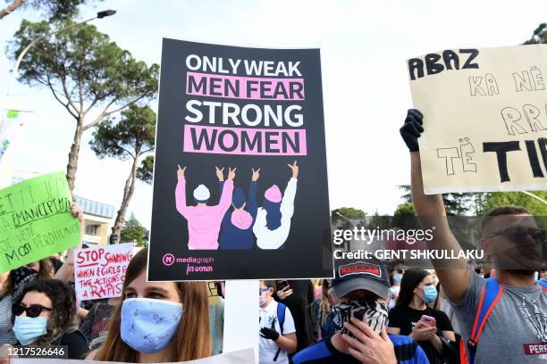 Albanian youngsters hold banners and shout slogans as they protest against sexual violence against women and minors and a culture that blames the...