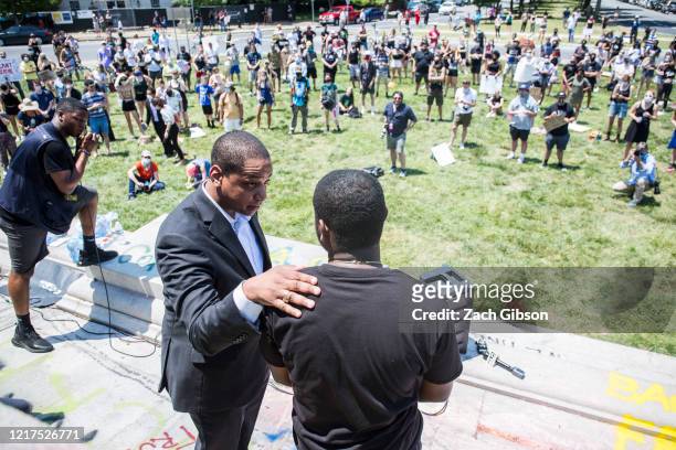 Virginia Lieutenant Gov. Justin Fairfax speaks to Corey Stuckey of the 381 Movement after addressing demonstrators in front of a statue of...