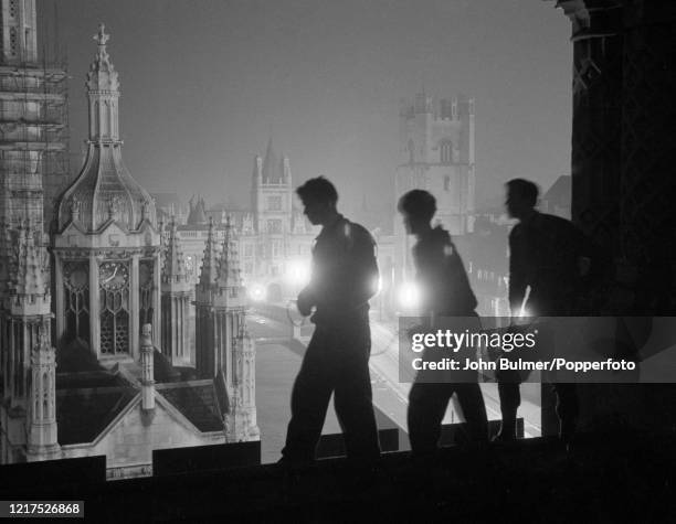 Students night climbing on the roof of one of the historic buildings at Cambridge University, in Cambridge, England, circa June 1959. Night climbing...