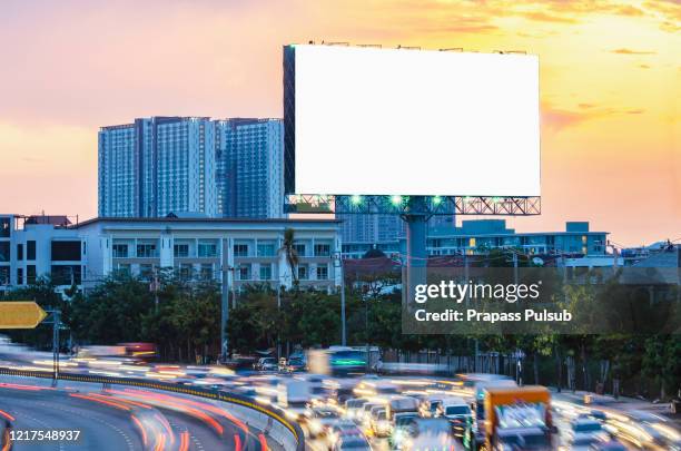 billboard on the highway during the twilight with city background with clipping path on screen - highway billboard stock pictures, royalty-free photos & images