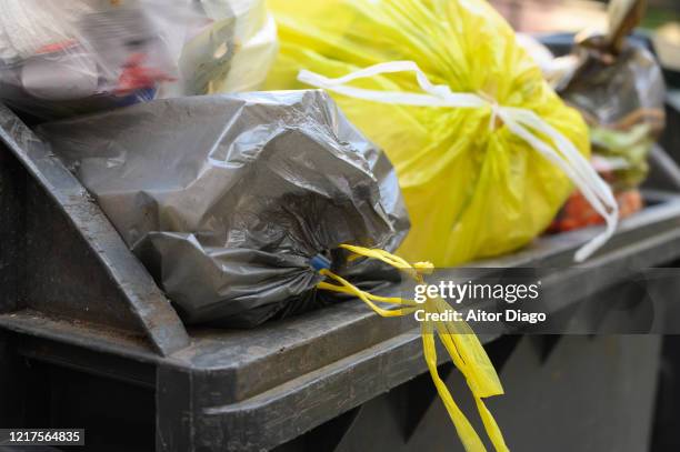 container full of garbage bags. berlin. germany. - industrial garbage bin fotografías e imágenes de stock