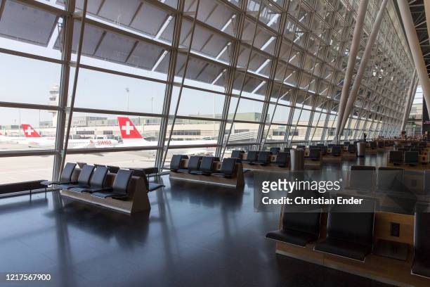 The Airport departure area stands devoid of passengers at nearly-empty Zurich Airport during the coronavirus crisis on April 2, 2020 in Zurich,...