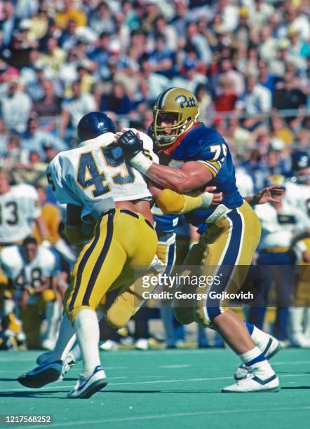 Offensive lineman Bill Fralic of the University of Pittsburgh Panthers blocks linebacker Steve Hathaway of the West Virginia Mountaineers during a...