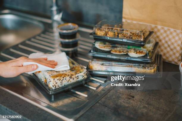 woman disinfecting takeaway sushi boxes - disposable stock pictures, royalty-free photos & images