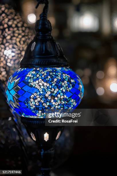 Colorful blue Moroccan lamp with blue glass mosaic design. Oriental style.