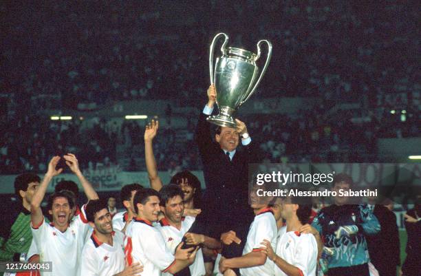 Silvio Berlusconi President of AC Milan lifts the trophy with his team after winnigns the European Cup Final during the match between AC Milan and...