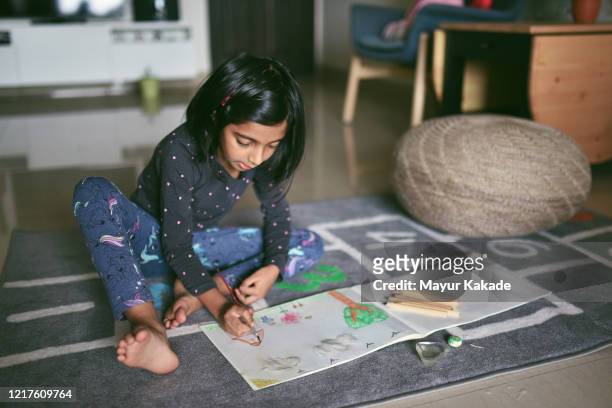 Girl colouring picture at home