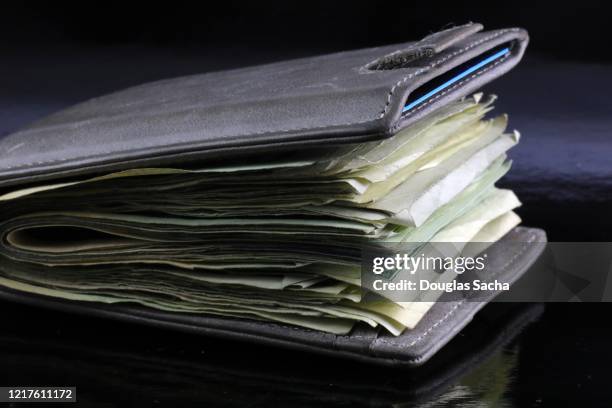 wallet filled with paper currency - full wallet stock pictures, royalty-free photos & images