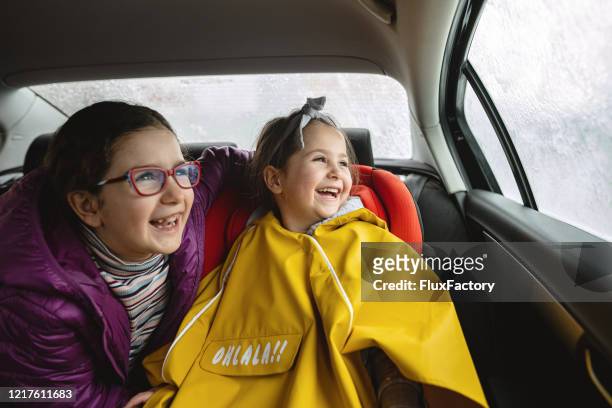 belas jovens se divertindo durante um lava-jato sentado dentro do carro - family inside car - fotografias e filmes do acervo