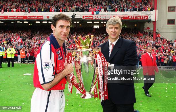 Martin Keown of Arsenal and Arsene Wenger the Arsenal Manager with the Premier League trophy after the match between Arsenal and Everton on May 11,...
