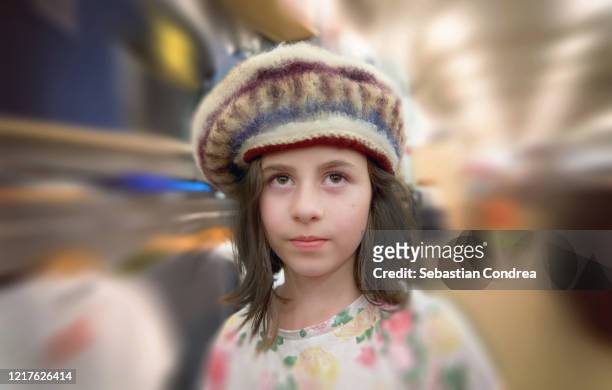 girl in a clothing store with the hat and portrait in virtual background. - portrait blurred background stockfoto's en -beelden