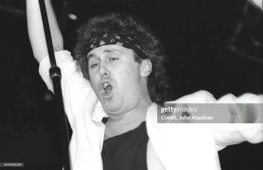 Singer Mike Reno Is Shown Performing On Stage During A live Concert singer-mike-reno-is-shown-performing-on-stage-during-a-live-concert