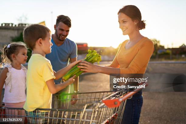 family having fun after grocery shopping - man pushing cart fun play stock pictures, royalty-free photos & images