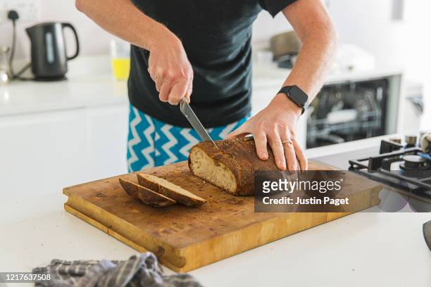 cutting freshly home made artisan bread - knife kitchen stock pictures, royalty-free photos & images