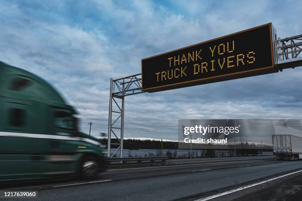 trucking during state of emergency - motorway sign stock pictures, royalty-free photos & images