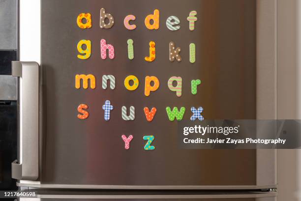 magnetic letters forming the alphabet - fridge door stock-fotos und bilder