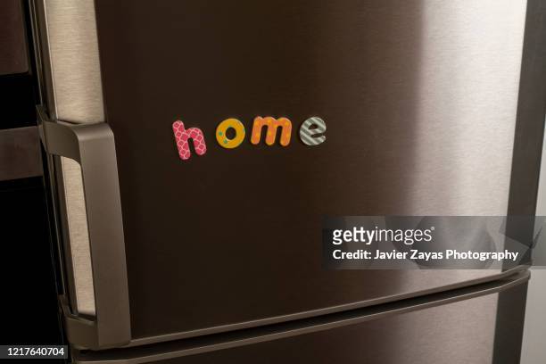 magnetic letters forming the word "home" - refrigerator door stock pictures, royalty-free photos & images