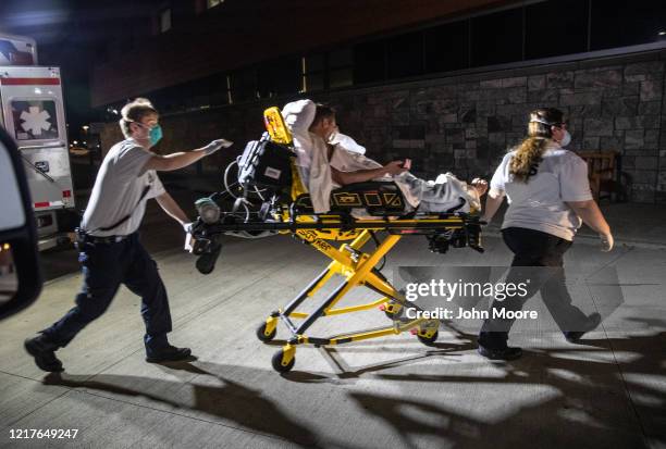 Medics arrive to Stamford Hospital with a patient with possible COVID-19 symptoms on April 03, 2020 in Stamford, Connecticut. In normal times many...