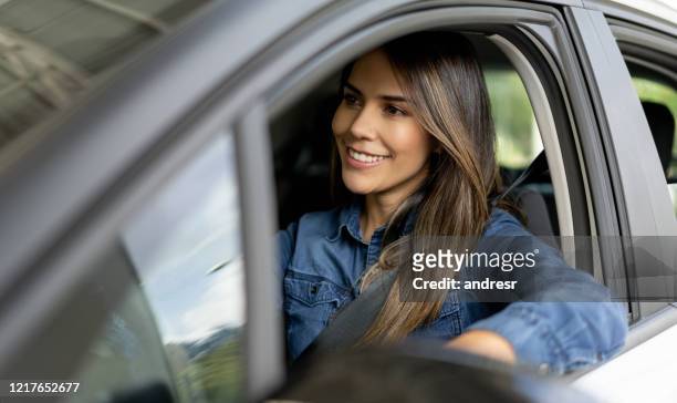 woman at a showroom going for a test drive in a car - latin american and hispanic ethnicity driver stock pictures, royalty-free photos & images