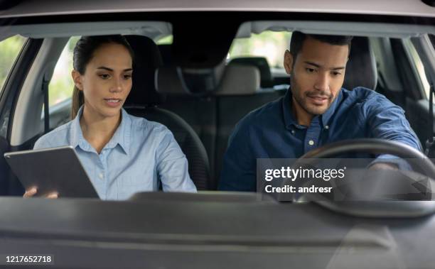 saleswoman talking to a man interested in buying a car at the dealership - test drive stock pictures, royalty-free photos & images