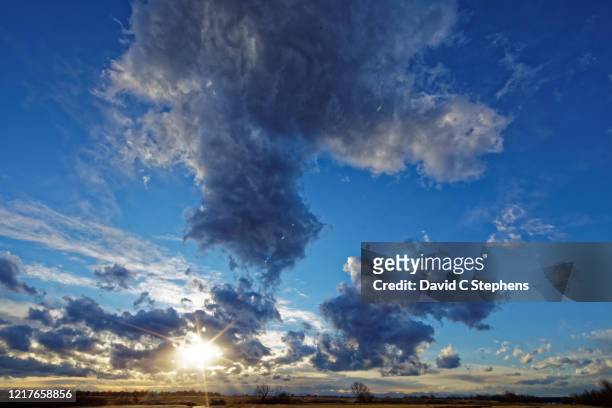 beautiful cloudscape with sun-star, lens flare, with lots of blue - aurora colorado stock-fotos und bilder